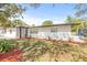 Newly renovated single story home with a gray door and freshly landscaped yard at 1114 La Salle St, Clearwater, FL 33755