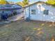 Backyard view of home with covered patio and AC unit at 1318 Preston S St, St Petersburg, FL 33712