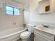 Clean bathroom with white tile, bathtub and vanity at 1318 Preston S St, St Petersburg, FL 33712