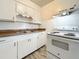 Efficient kitchen with white cabinets and wood-look countertops at 1318 Preston S St, St Petersburg, FL 33712
