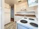 Efficient kitchen with white cabinets and wood-look countertops at 1318 Preston S St, St Petersburg, FL 33712