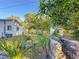 Backyard view of home with shed and lush landscaping at 1318 Preston S St, St Petersburg, FL 33712