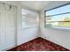 Sunroom with parquet flooring, window and exterior door at 1318 Preston S St, St Petersburg, FL 33712