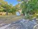 Backyard with grassy area, trees, and a small shed at 1318 Preston S St, St Petersburg, FL 33712