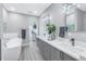 Modern bathroom with double vanity, freestanding tub, and walk-in shower at 12400 Capri N Cir # B, Treasure Island, FL 33706