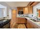 Kitchen with light wood cabinets, granite countertops, and stainless steel appliances at 1265 Magnolia Dr, Clearwater, FL 33756