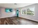 Bright living room featuring wood-look floors and a large window at 1265 Magnolia Dr, Clearwater, FL 33756