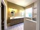 Modern bathroom with double vanity, granite countertops, and glass enclosed shower at 15810 Cobble Mill Dr, Wimauma, FL 33598
