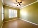 Bedroom featuring tile flooring, ceiling fan, and plantation shutters for enhanced natural light control at 15810 Cobble Mill Dr, Wimauma, FL 33598