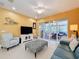 Comfortable living room with a ceiling fan, tile flooring, and sliding glass doors leading to the lanai at 15810 Cobble Mill Dr, Wimauma, FL 33598