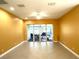 Bright living room with tile flooring, ceiling fan, and screened patio access at 15810 Cobble Mill Dr, Wimauma, FL 33598