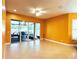 Open living area with tile flooring, ceiling fan, and access to a screened lanai, perfect for indoor/outdoor living at 15810 Cobble Mill Dr, Wimauma, FL 33598
