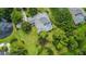 Aerial view showcasing the home's private pool area, screened-in patio, expansive yard, and mature landscaping at 168 Rue Des Chateaux, Tarpon Springs, FL 34688