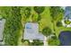 Aerial view showcasing the home's private pool area, screened-in patio, expansive yard, and mature landscaping at 168 Rue Des Chateaux, Tarpon Springs, FL 34688
