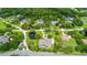 Aerial view of the home in a lushly landscaped neighborhood with mature trees, ponds, and well-maintained lawns at 168 Rue Des Chateaux, Tarpon Springs, FL 34688