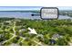 Aerial view of the home near Lake Tarpon, surrounded by mature trees and lush landscaping in a desirable neighborhood at 168 Rue Des Chateaux, Tarpon Springs, FL 34688