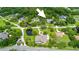 Aerial view of the home in a lushly landscaped neighborhood with mature trees, ponds, and well-maintained lawns at 168 Rue Des Chateaux, Tarpon Springs, FL 34688