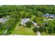 Aerial view of a home with private pool area, screened-in patio, expansive yard, and mature landscaping at 168 Rue Des Chateaux, Tarpon Springs, FL 34688