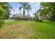 Large screened-in patio in a spacious backyard, perfect for outdoor living and entertaining at 168 Rue Des Chateaux, Tarpon Springs, FL 34688