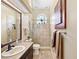 Bright bathroom featuring a walk-in shower with tile surround, a large mirror, and a neutral color palette at 168 Rue Des Chateaux, Tarpon Springs, FL 34688