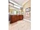 Double vanity in elegant bathroom featuring tiled floor, and a large mirror at 168 Rue Des Chateaux, Tarpon Springs, FL 34688