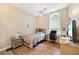 Comfortable bedroom with wood floors, large window, ceiling fan, and neutral paint. Ideal for relaxing and resting at 168 Rue Des Chateaux, Tarpon Springs, FL 34688