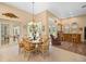 Dining area with chandelier and views of the pool at 168 Rue Des Chateaux, Tarpon Springs, FL 34688