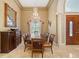 Elegant dining room with a chandelier, large window, and a formal dining table at 168 Rue Des Chateaux, Tarpon Springs, FL 34688