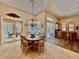 Elegant dining room with pool view, chandelier, and seating for six at 168 Rue Des Chateaux, Tarpon Springs, FL 34688