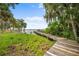 Picturesque dock providing waterfront views, surrounded by lush greenery and trees at 168 Rue Des Chateaux, Tarpon Springs, FL 34688
