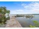Waterfront home's wooden dock on a sunny day, offering serene water views and boat access at 168 Rue Des Chateaux, Tarpon Springs, FL 34688