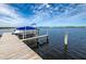 Dock and boat overlooking lake, offering scenic waterfront views and recreational opportunities at 168 Rue Des Chateaux, Tarpon Springs, FL 34688