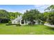 Charming single-story home with a manicured lawn and mature oak tree in the front yard at 168 Rue Des Chateaux, Tarpon Springs, FL 34688