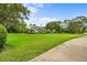 Expansive front lawn showcasing a well-maintained exterior and lush landscaping for great curb appeal at 168 Rue Des Chateaux, Tarpon Springs, FL 34688