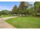 Lovely front yard with mature trees, providing privacy and a picturesque setting for this home at 168 Rue Des Chateaux, Tarpon Springs, FL 34688