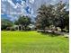 Expansive lawn and mature trees complement this single-story home with a classic architectural design at 168 Rue Des Chateaux, Tarpon Springs, FL 34688