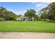 Charming single-story home with a sprawling lawn and mature trees, offering both curb appeal and a sense of privacy at 168 Rue Des Chateaux, Tarpon Springs, FL 34688
