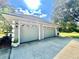 Two-car garage featuring decorative windows and gray doors, with landscaped touches enhancing curb appeal at 168 Rue Des Chateaux, Tarpon Springs, FL 34688