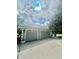 Attached two-car garage with decorative windows, offering ample parking and storage space at 168 Rue Des Chateaux, Tarpon Springs, FL 34688