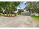 Charming home featuring a three-car garage on a well-manicured lawn and beautiful trees at 168 Rue Des Chateaux, Tarpon Springs, FL 34688
