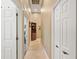 Hallway with tile flooring, natural light, and storage closets at 168 Rue Des Chateaux, Tarpon Springs, FL 34688