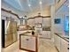 Spacious kitchen with ample storage, stainless steel refrigerator, and center island at 168 Rue Des Chateaux, Tarpon Springs, FL 34688