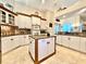 Stylish kitchen with white cabinets, granite countertops, and a center island at 168 Rue Des Chateaux, Tarpon Springs, FL 34688
