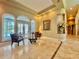 Elegant living room featuring marble floors, stylish furnishings, and access to an outdoor pool at 168 Rue Des Chateaux, Tarpon Springs, FL 34688