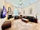 The living room features a stone fireplace, vaulted ceiling, and neutral decor with windows allowing for natural lighting at 168 Rue Des Chateaux, Tarpon Springs, FL 34688