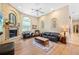 Comfortable living room features a stone fireplace and hardwood floors at 168 Rue Des Chateaux, Tarpon Springs, FL 34688