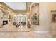 Cozy living room with a fireplace, arched windows, and stylish furnishings, inviting relaxation at 168 Rue Des Chateaux, Tarpon Springs, FL 34688