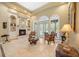Cozy living room with a fireplace, arched windows, and stylish furnishings, inviting relaxation at 168 Rue Des Chateaux, Tarpon Springs, FL 34688