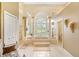 Luxurious bathroom with a garden tub, pillars, a walk-in shower, and decorative wall sconces at 168 Rue Des Chateaux, Tarpon Springs, FL 34688