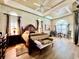 Large main bedroom featuring hardwood floors, a trey ceiling, and arched windows at 168 Rue Des Chateaux, Tarpon Springs, FL 34688